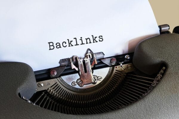 best ai seo tools - Close-up of a vintage typewriter printing the word 'Backlinks,' emphasizing content and SEO concepts.