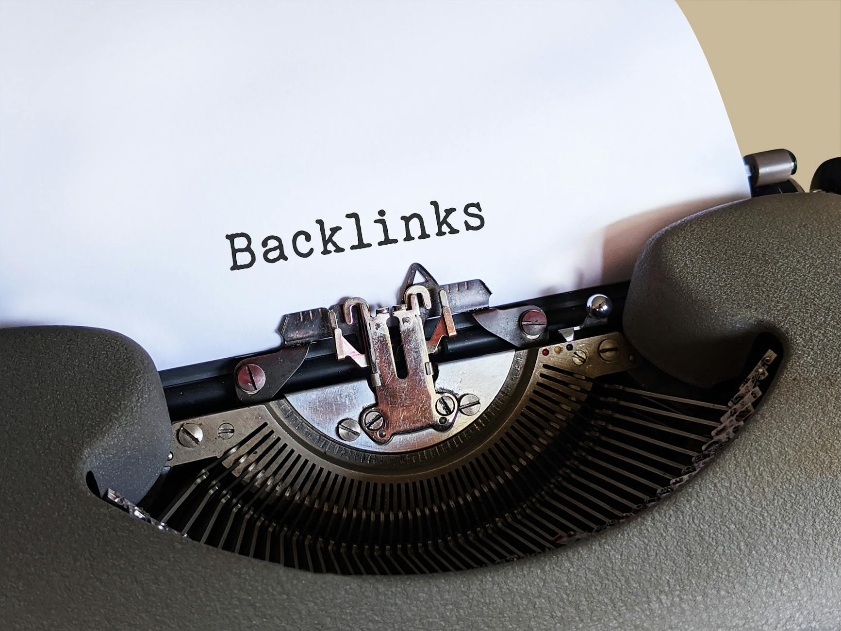 best ai seo tools - Close-up of a vintage typewriter printing the word 'Backlinks,' emphasizing content and SEO concepts.