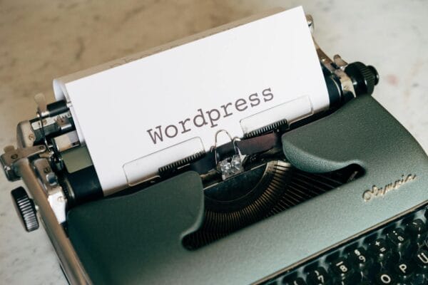 ai wordpress plugin - Close-up of a vintage typewriter with paper labeled Wordpress.