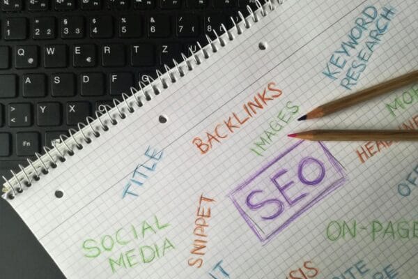 seo ai tools - Close-up of notebook with SEO terms and keywords, highlighting digital marketing strategy.