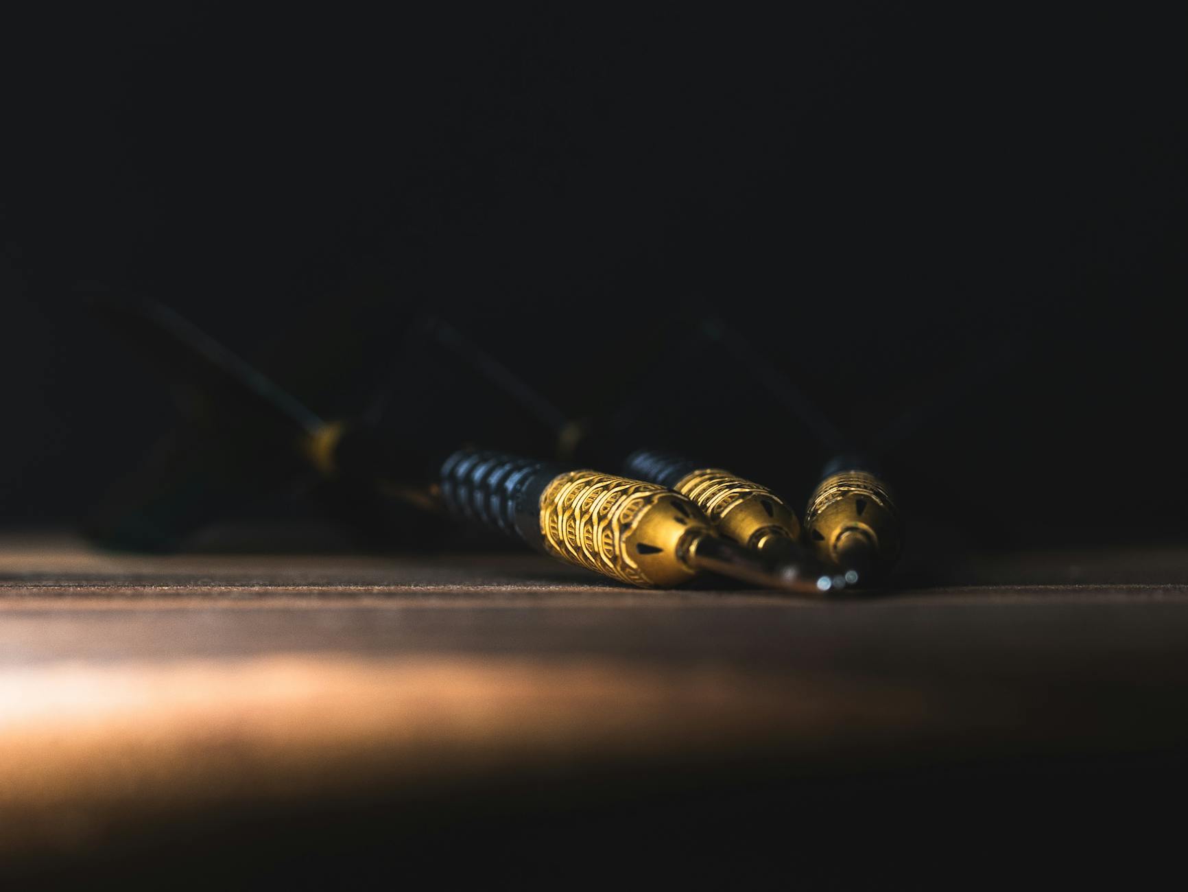campaign objective adalah - A detailed close-up of darts on a wooden surface in dramatic lighting, showcasing precision and focus.