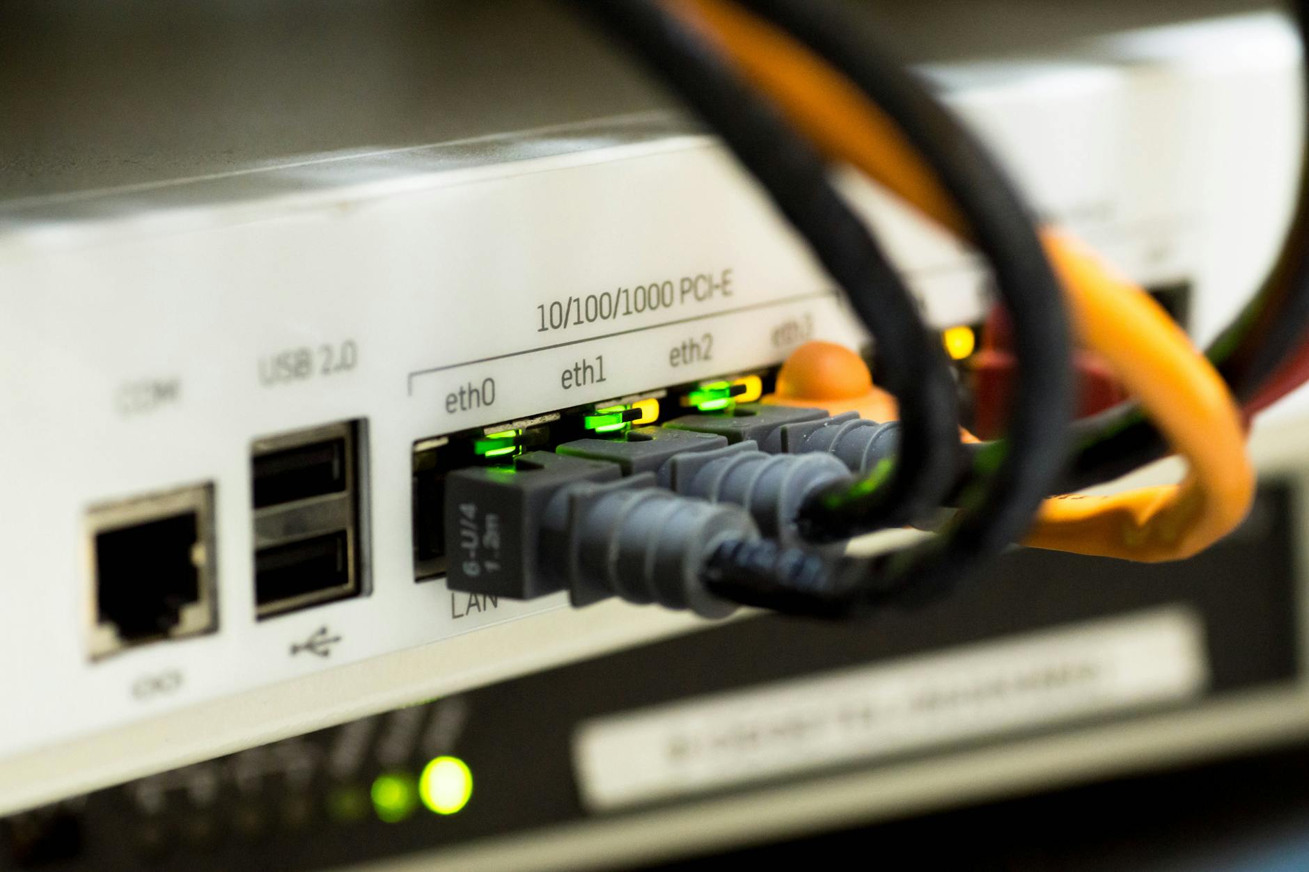 network request optimization - Detailed close-up of ethernet cables and network connections on a router, showcasing modern technology.