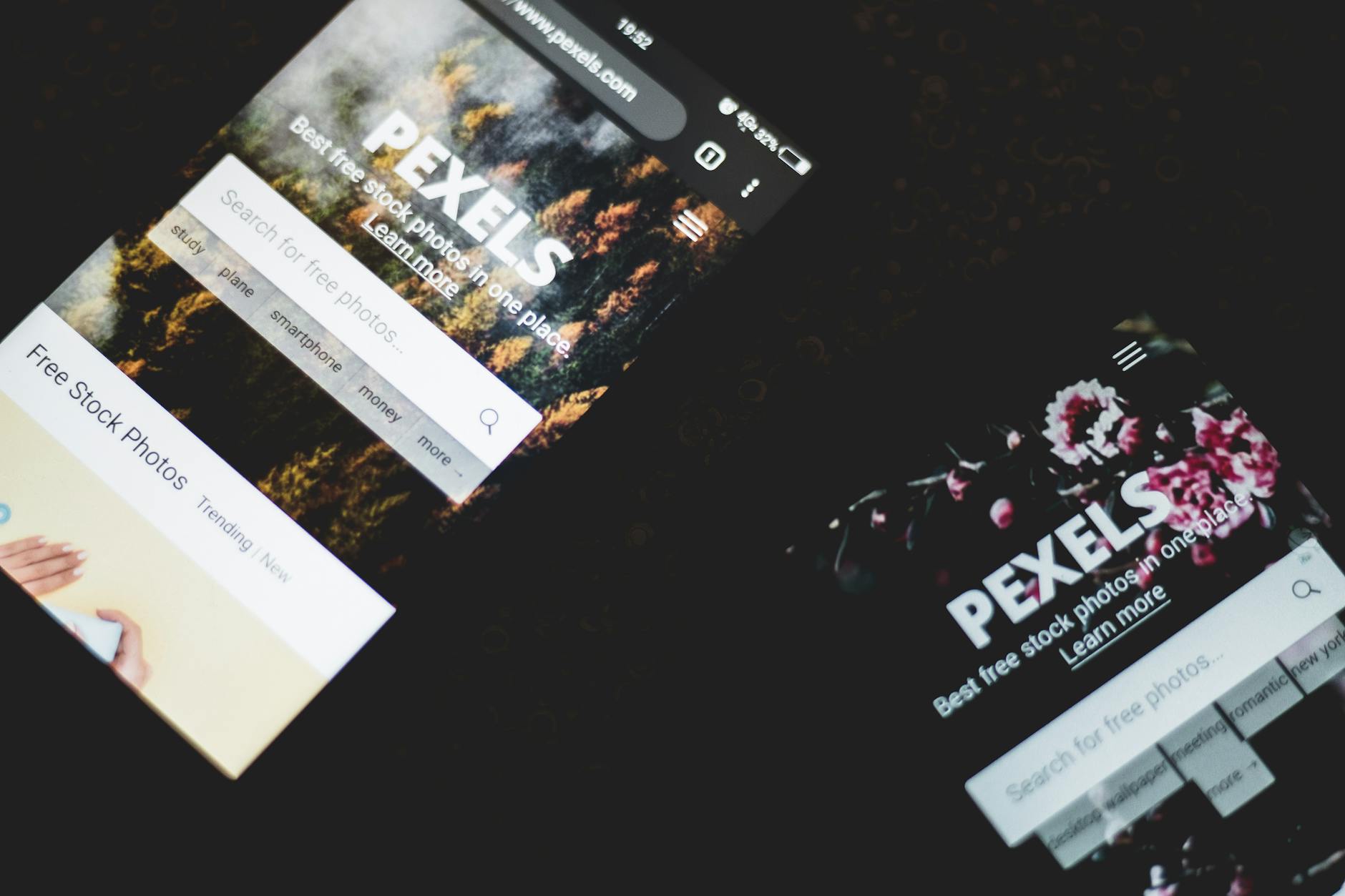 website tidak naik ranking - Close-up of smartphones displaying Pexels stock photo website, showcasing modern technology.