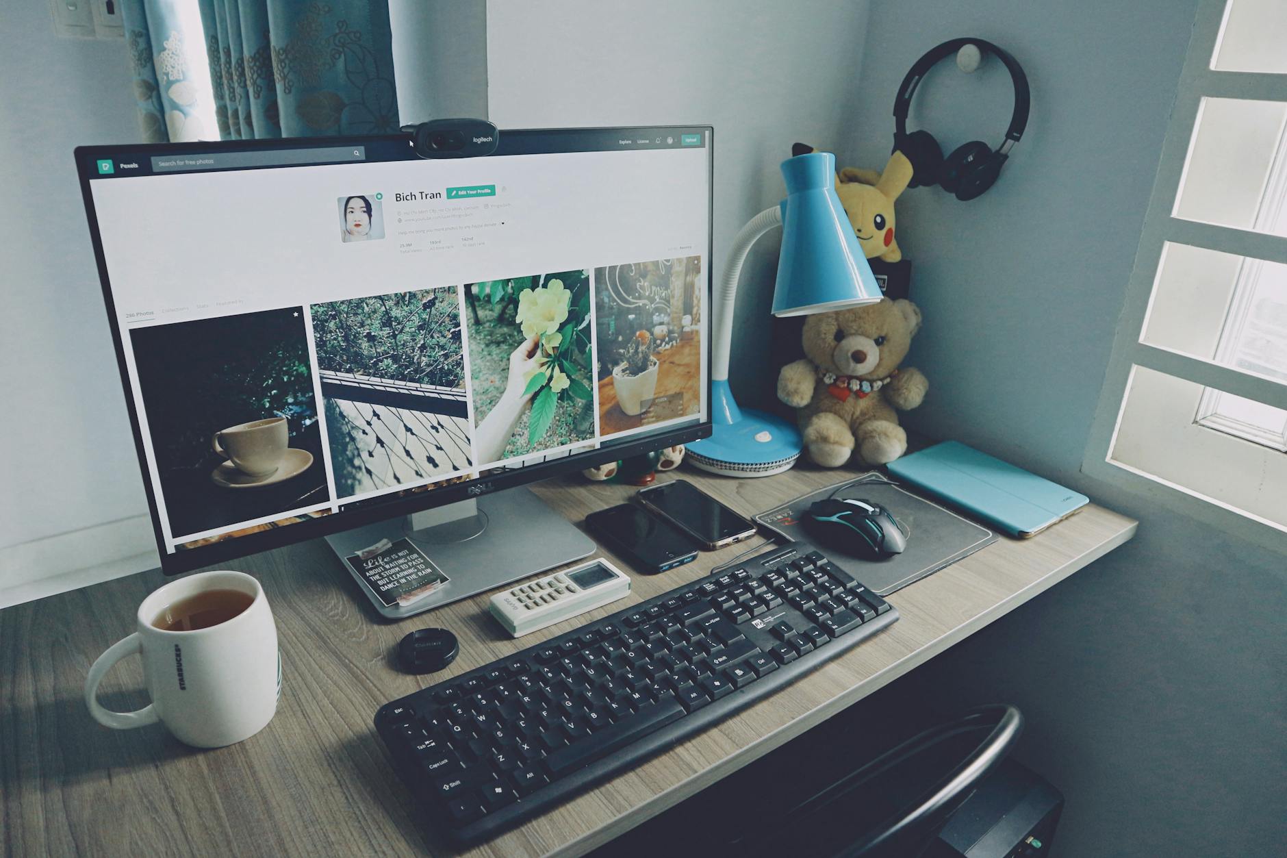 membuat website dengan wordpress - A tidy home office desk setup with a computer, keyboard, and personal items, creating a cozy work atmosphere.