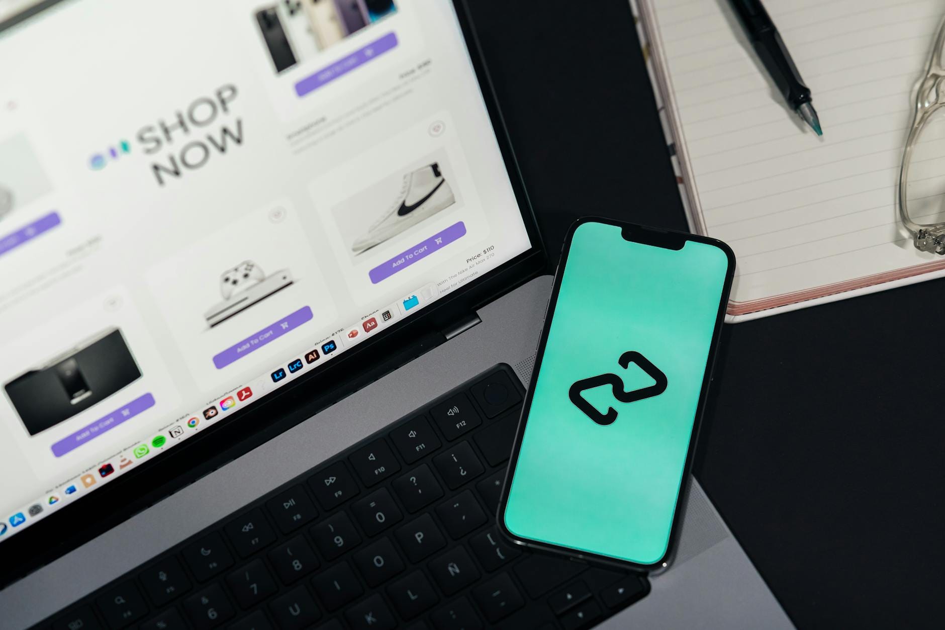 diagnose website performance - A smartphone and laptop displaying online shopping platforms, suggesting digital retail.