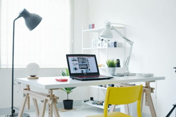 improve readability score - A bright white home office featuring a laptop and sleek contemporary design elements.